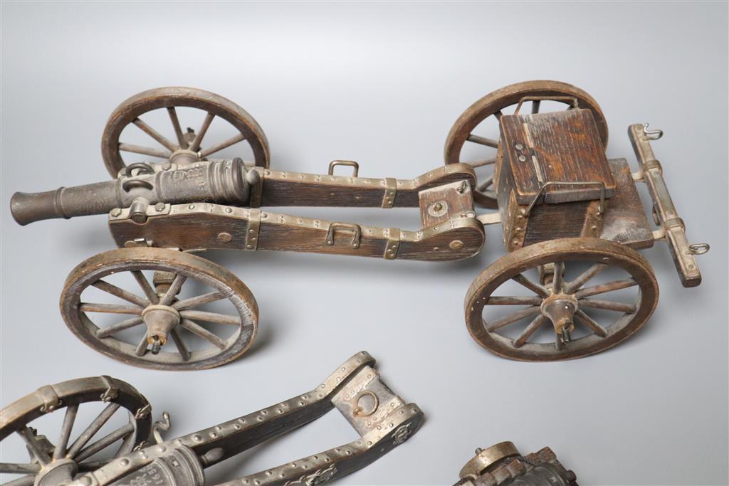 Three oak and wrought iron models of historic cannons, longest 39cm